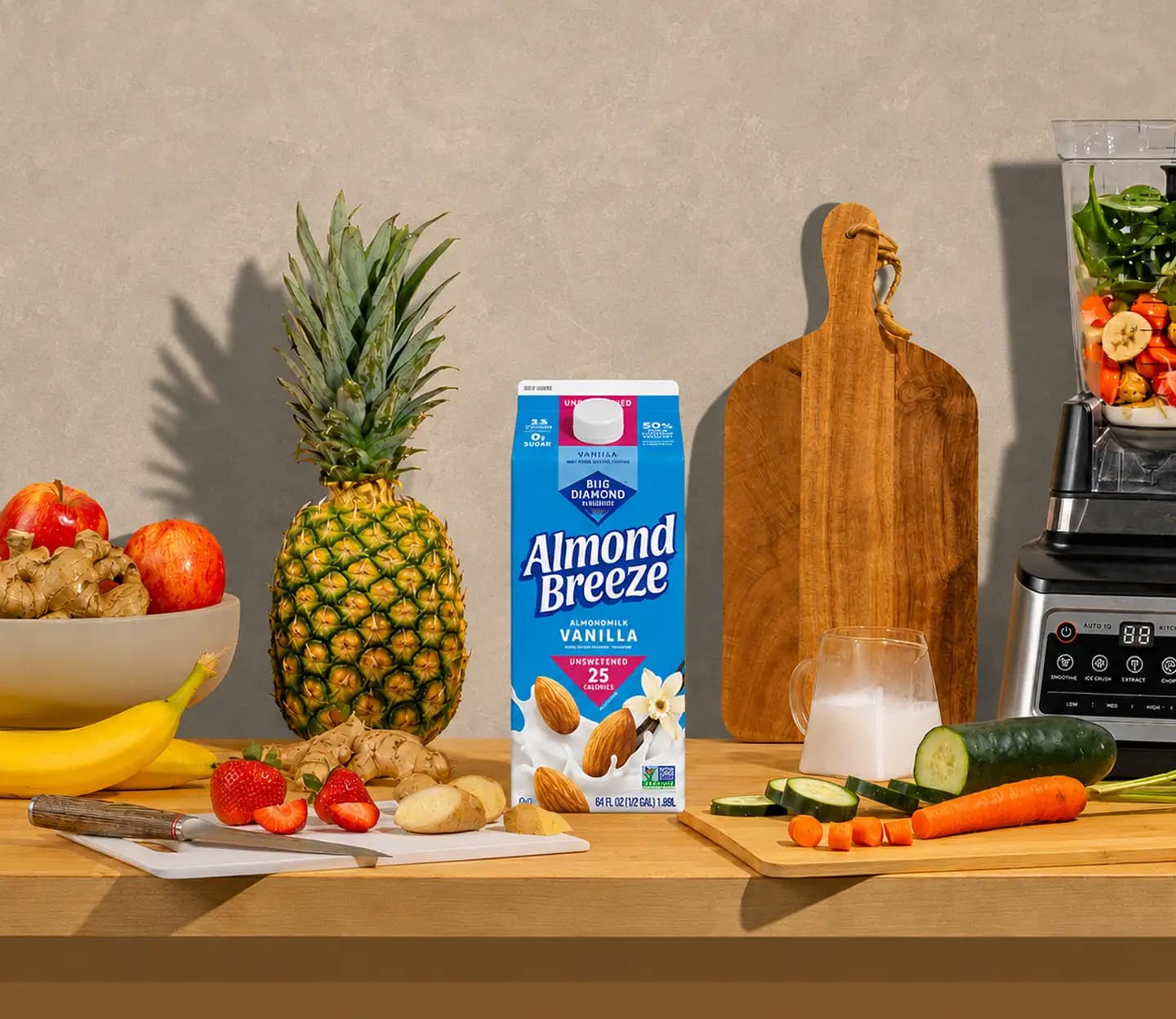 Almond Breeze on counter with blender, fruit and veggies