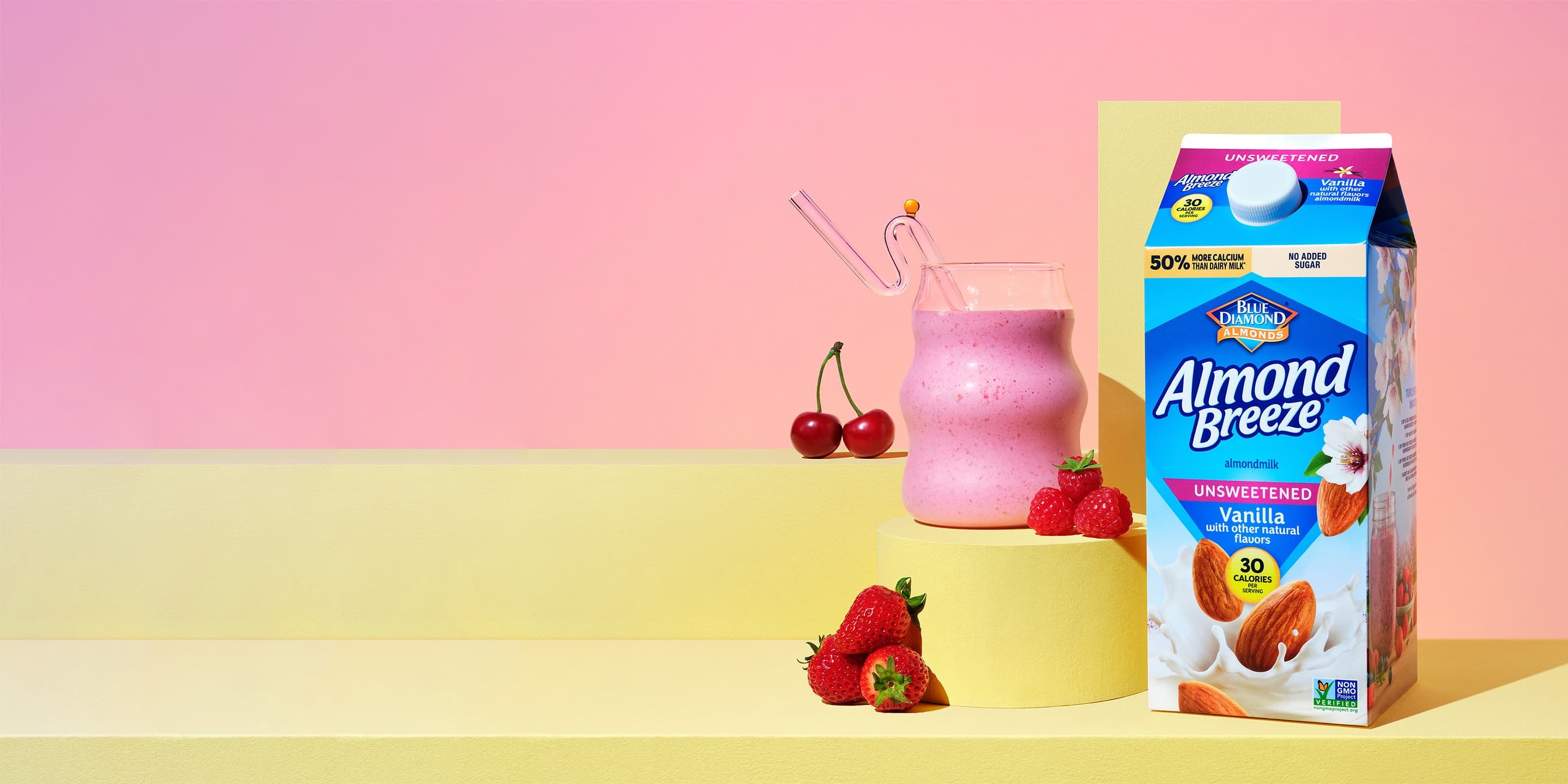 Almond breeze carton next to fruit smoothie