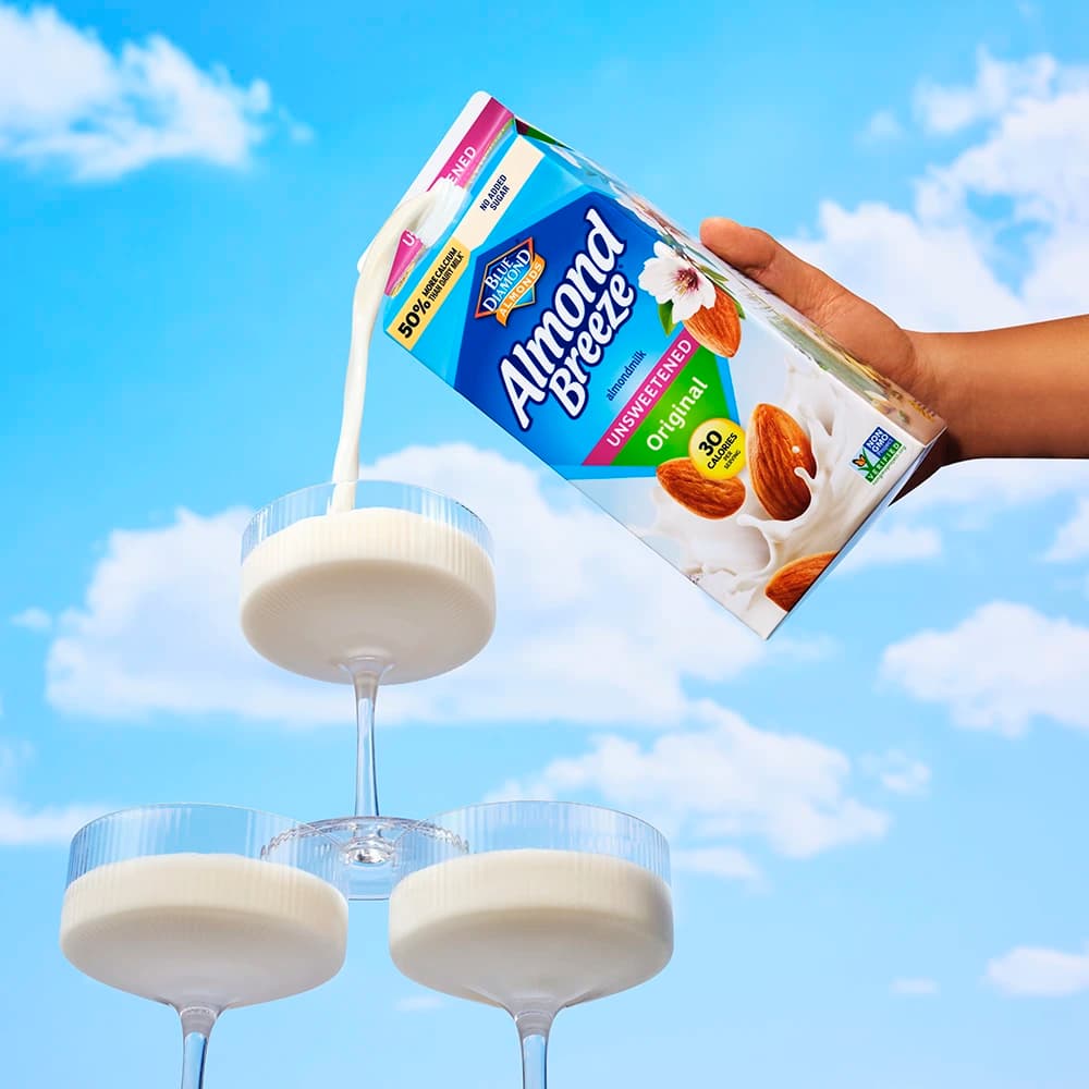 Almond breeze carton pouring into glasses