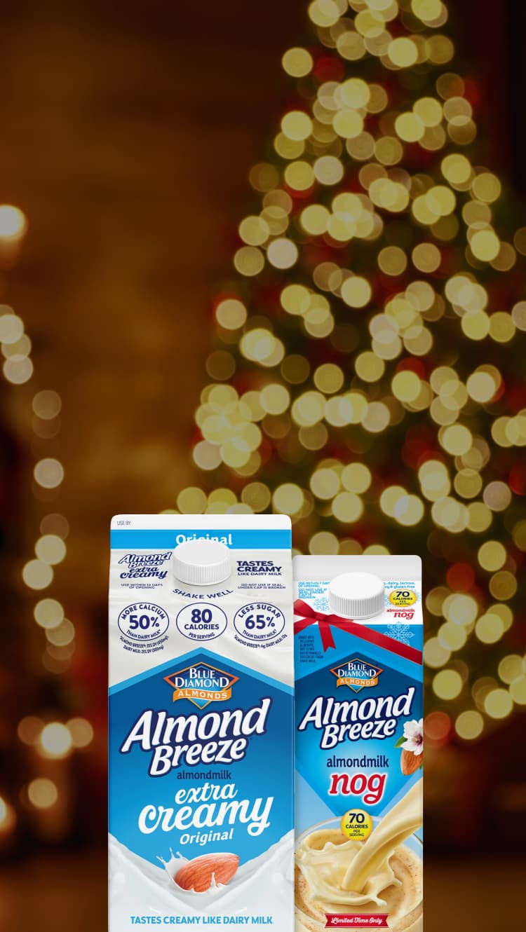 Cartons of almond breeze in front of lighted holiday tree