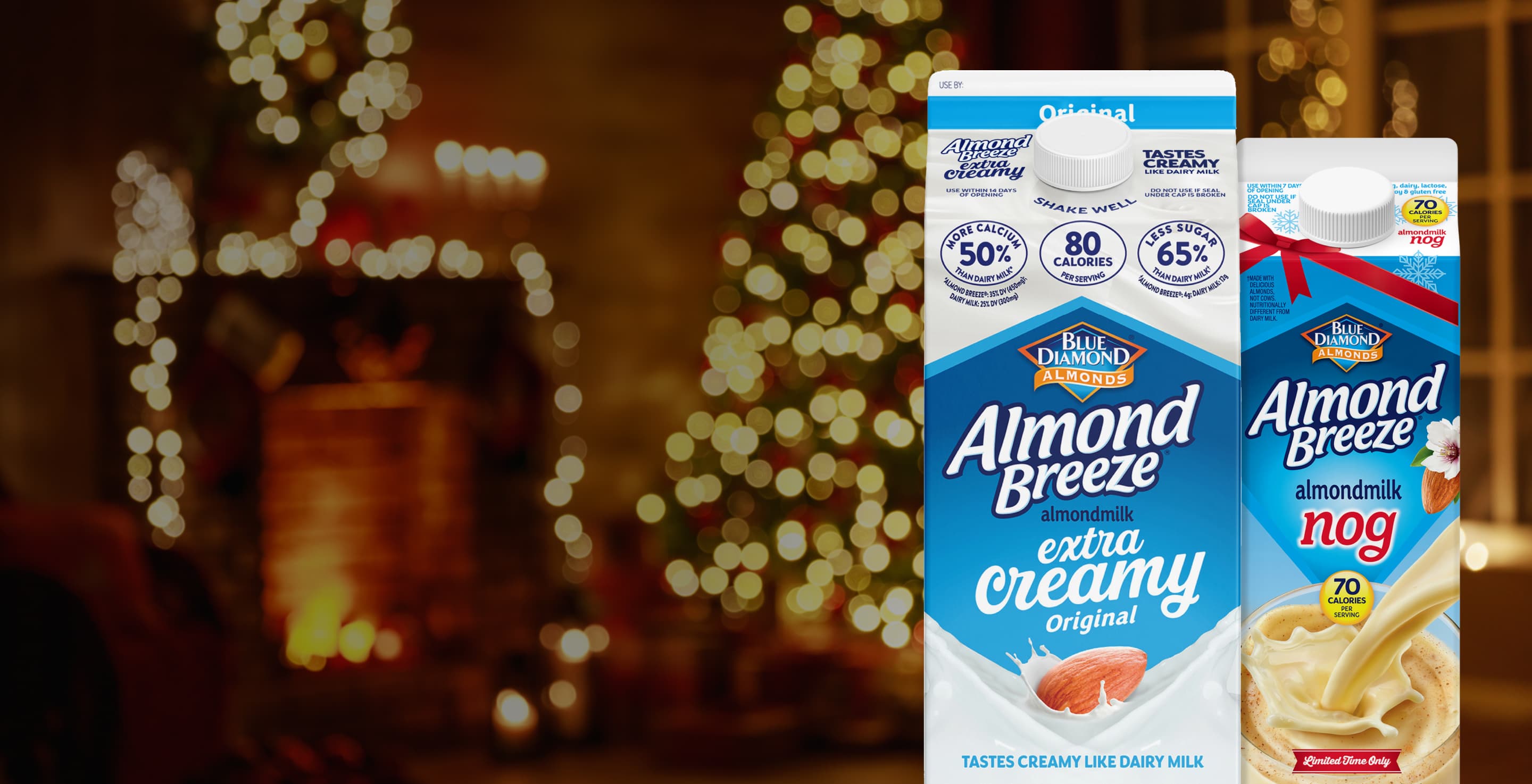 Cartons of almond breeze in front of lighted holiday tree and fireplace