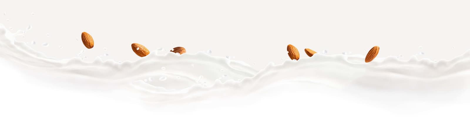 Almonds splashing into almondmilk.