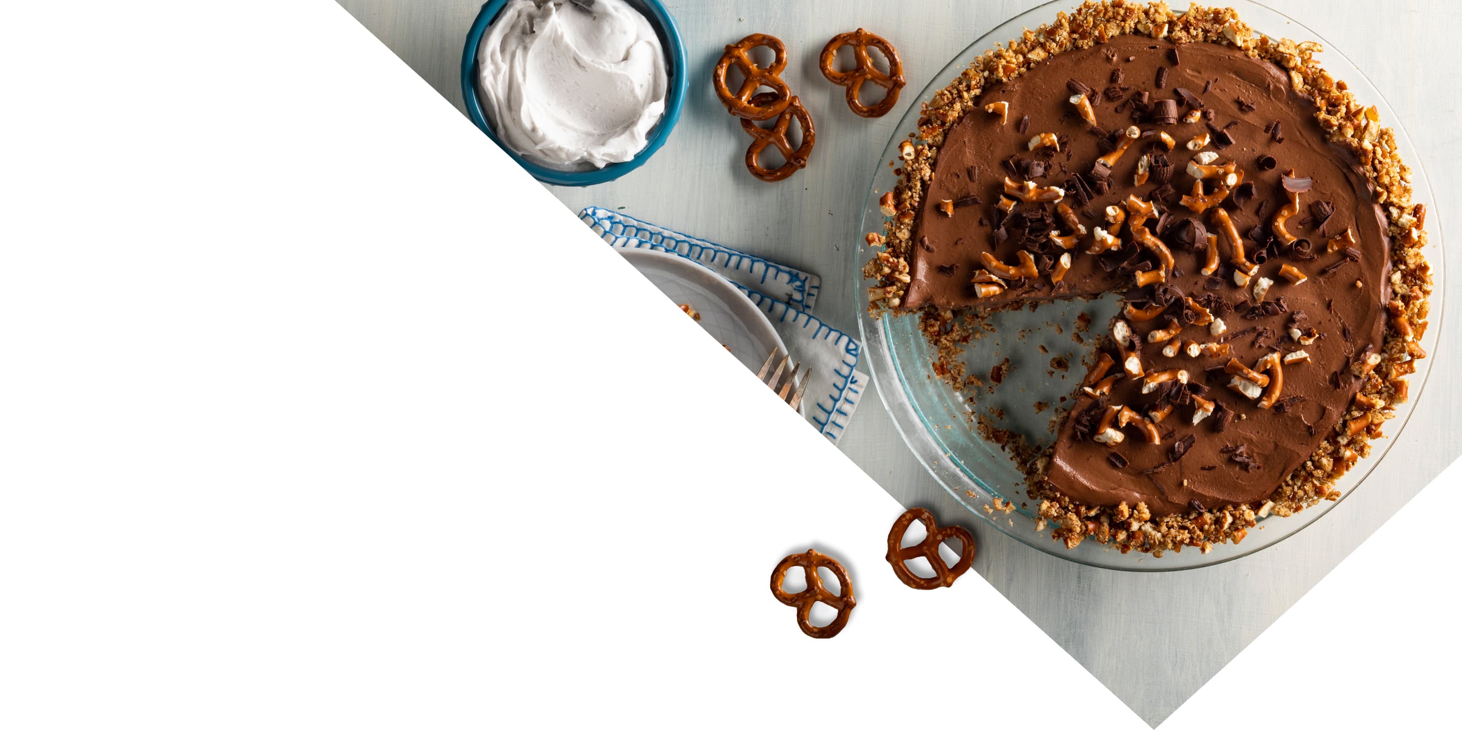 Table with vegan chocolate mousse topped with crushed pretzels and chocolate