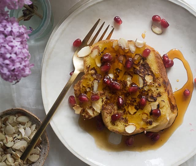 Plate full of almond french toast topped with syrup, fresh fruit, and Blue Diamond Sea Salt Almonds