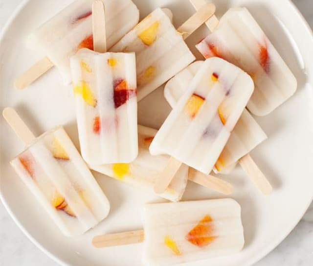 Plate full of dairy-free vanilla peach popsicles