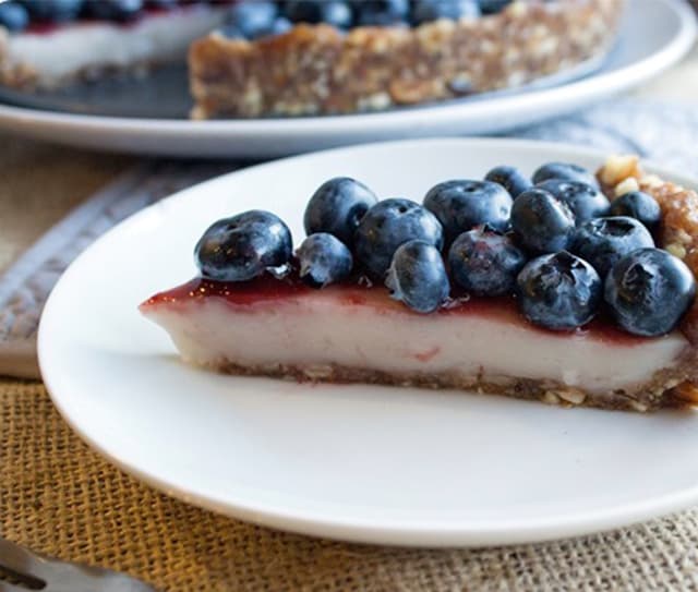 Slice of dairy-free no bake blueberry custard pie with fresh blueberries