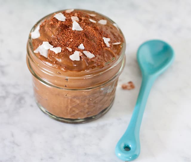 Jar of chocolate avocado pudding topped with Blue Diamond Dark Chocolate Flavored Almonds