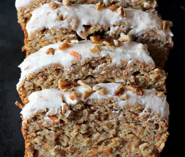 Slices of carrot cake banana bread with cream cheese frosting made with Almond Breeze Unsweetened Original Almondmilk