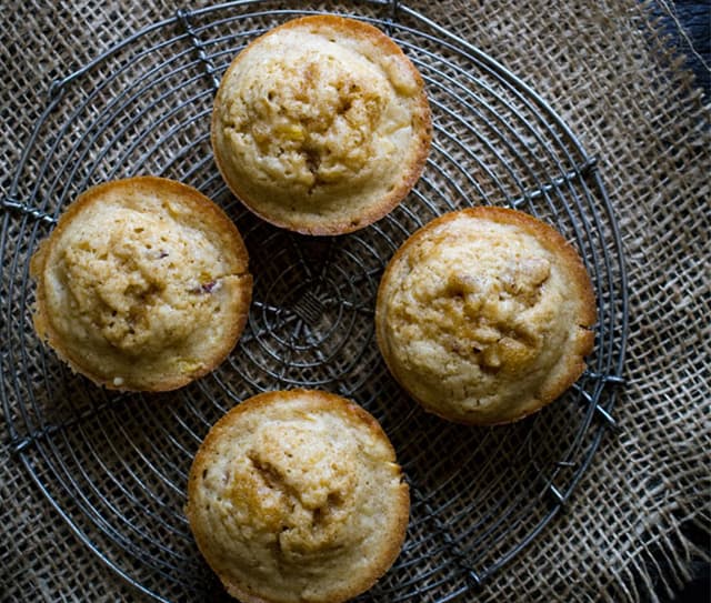 Plate with four brown butter nectarine muffins