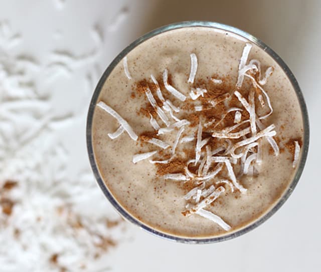 Bird's eye view of the almond and date smoothie topped with shredded coconut