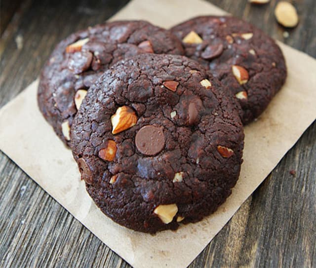 Plate full of vegan chocolate almond cookies with chocolate chips and Blue Diamond Almonds