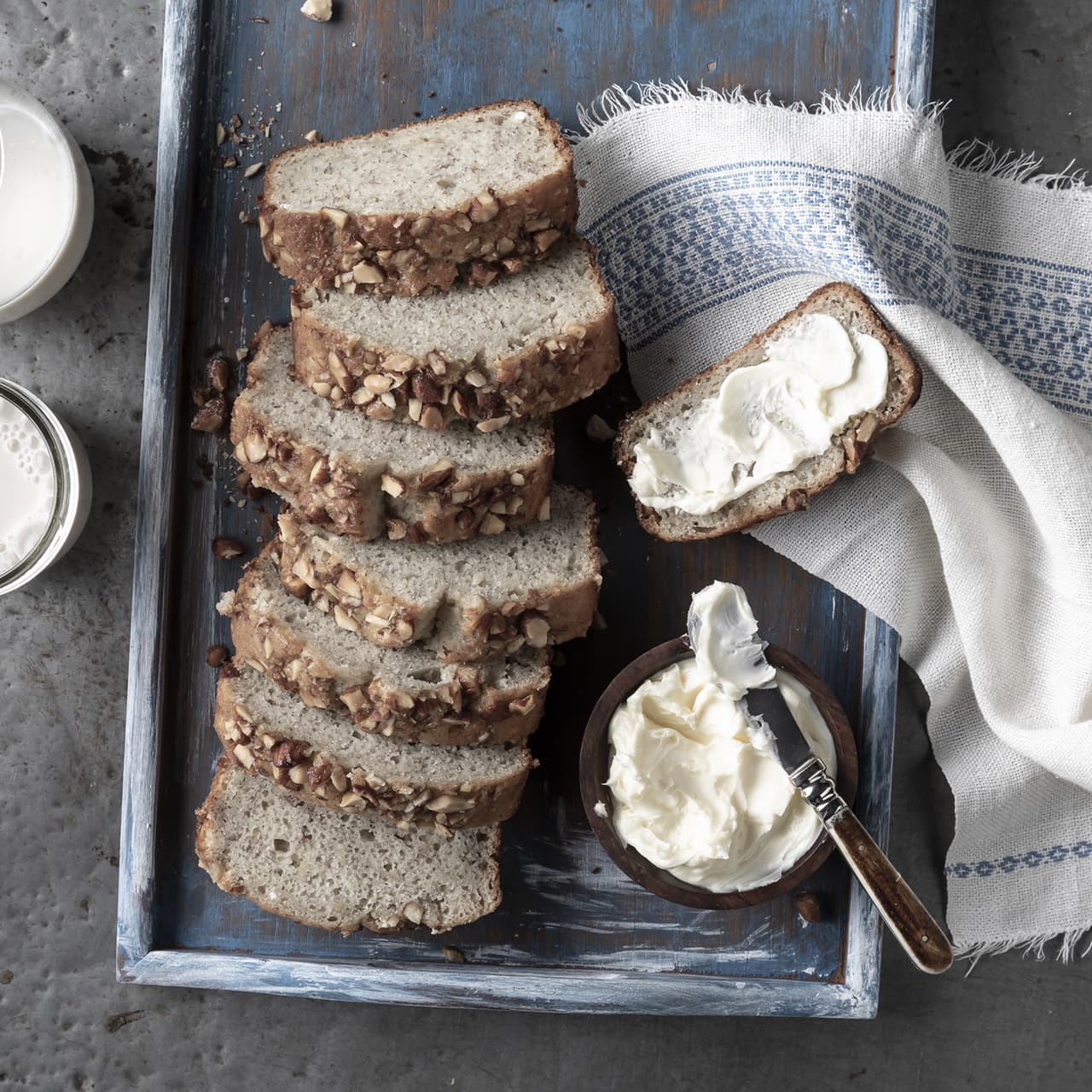 Platter full of sliced breeze banana bread topped with Blue Diamond Honey Roasted Almonds