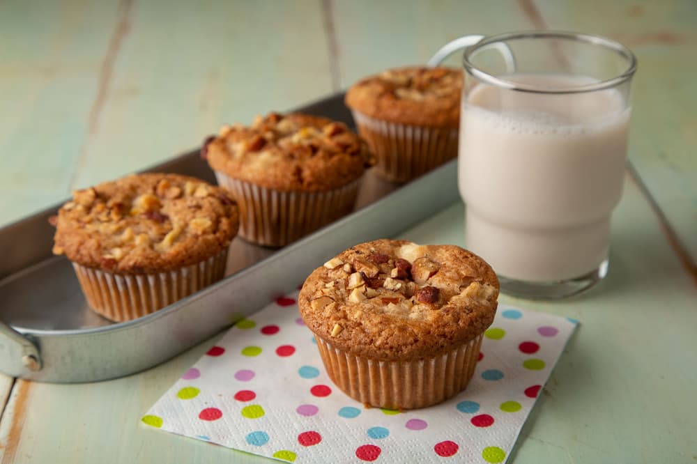 Apple cream cheese muffins, with Almond Breeze Vanilla Almondmilk in a glass to the side