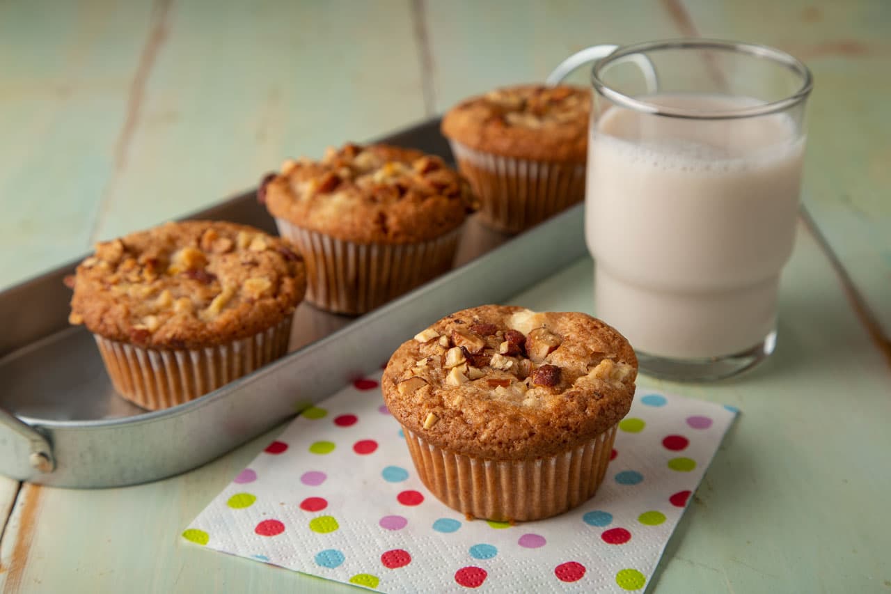 Apple cream cheese muffins, with Almond Breeze Vanilla Almondmilk in a glass to the side