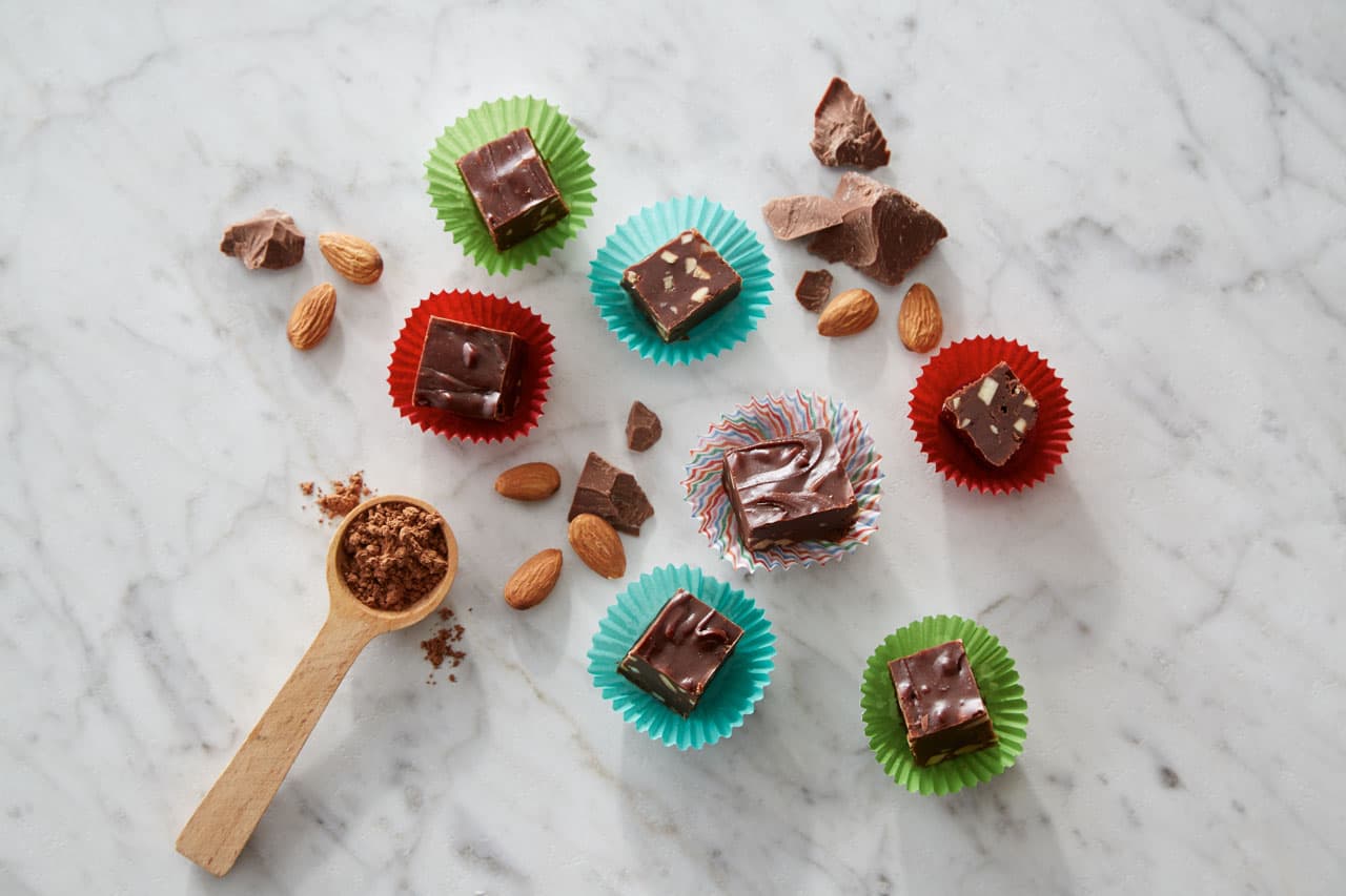 Chopped pieces of chocolate almond fudge on a counter