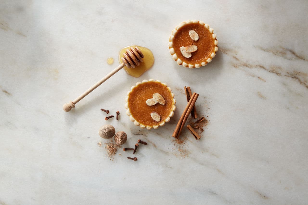 Two honey pumpkin mini tarts topped with shaved Blue Diamond Almonds