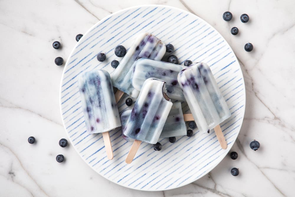 Plate full of dairy-free Almond Breeze blueberry ice pops