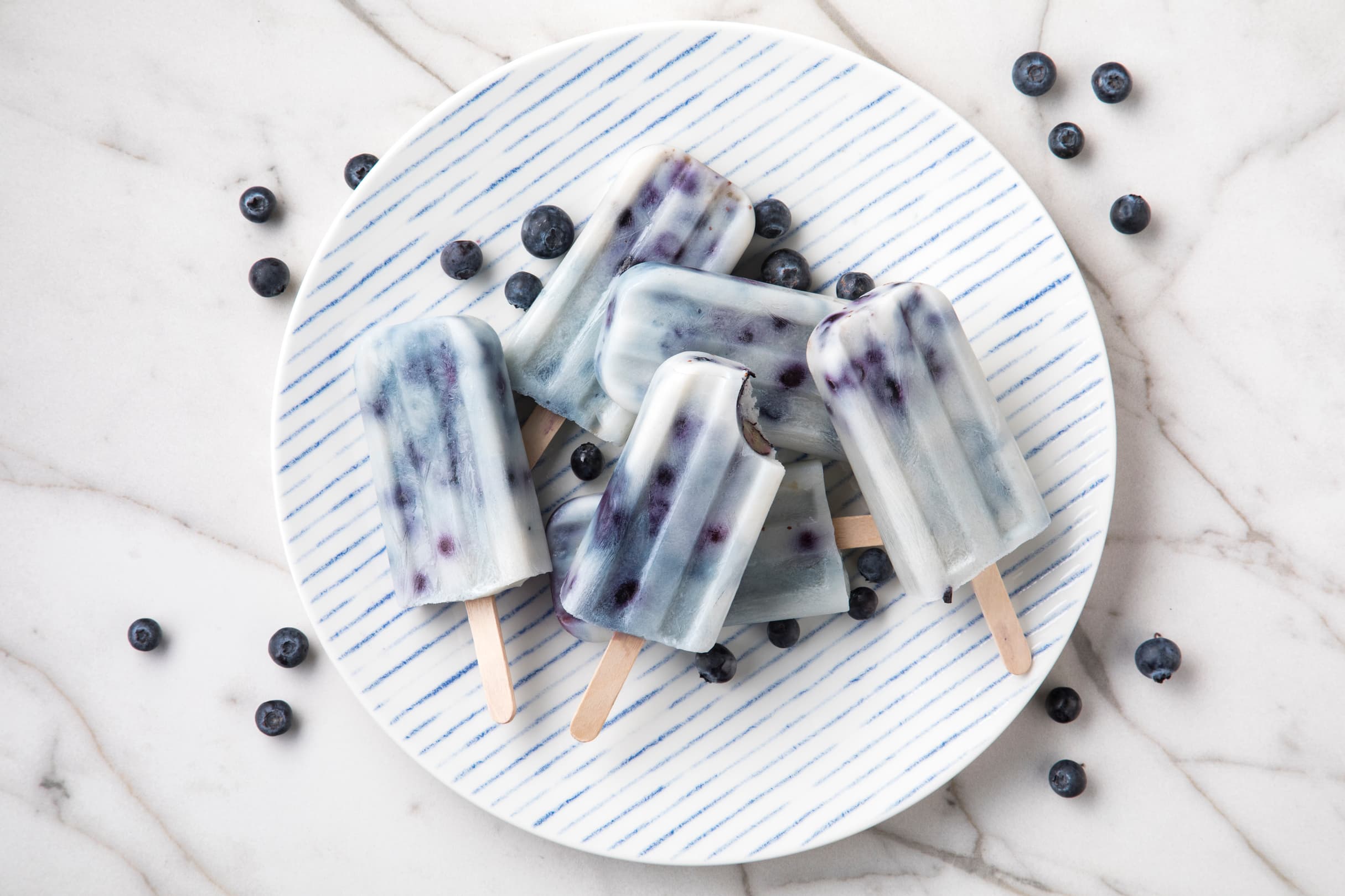 Plate full of dairy-free Almond Breeze blueberry ice pops