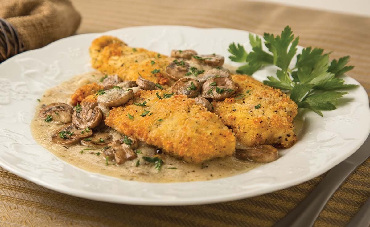 Two crispy chicken breasts smothered in marsala sauce