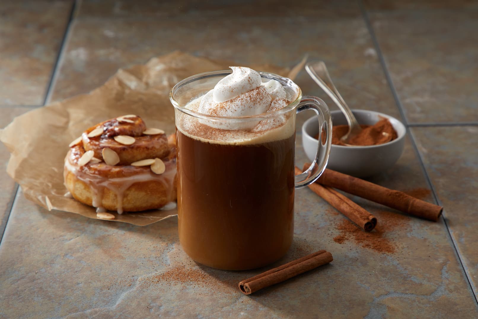 Mug of cinnamon roll hot coffee topped with whipped creamer
