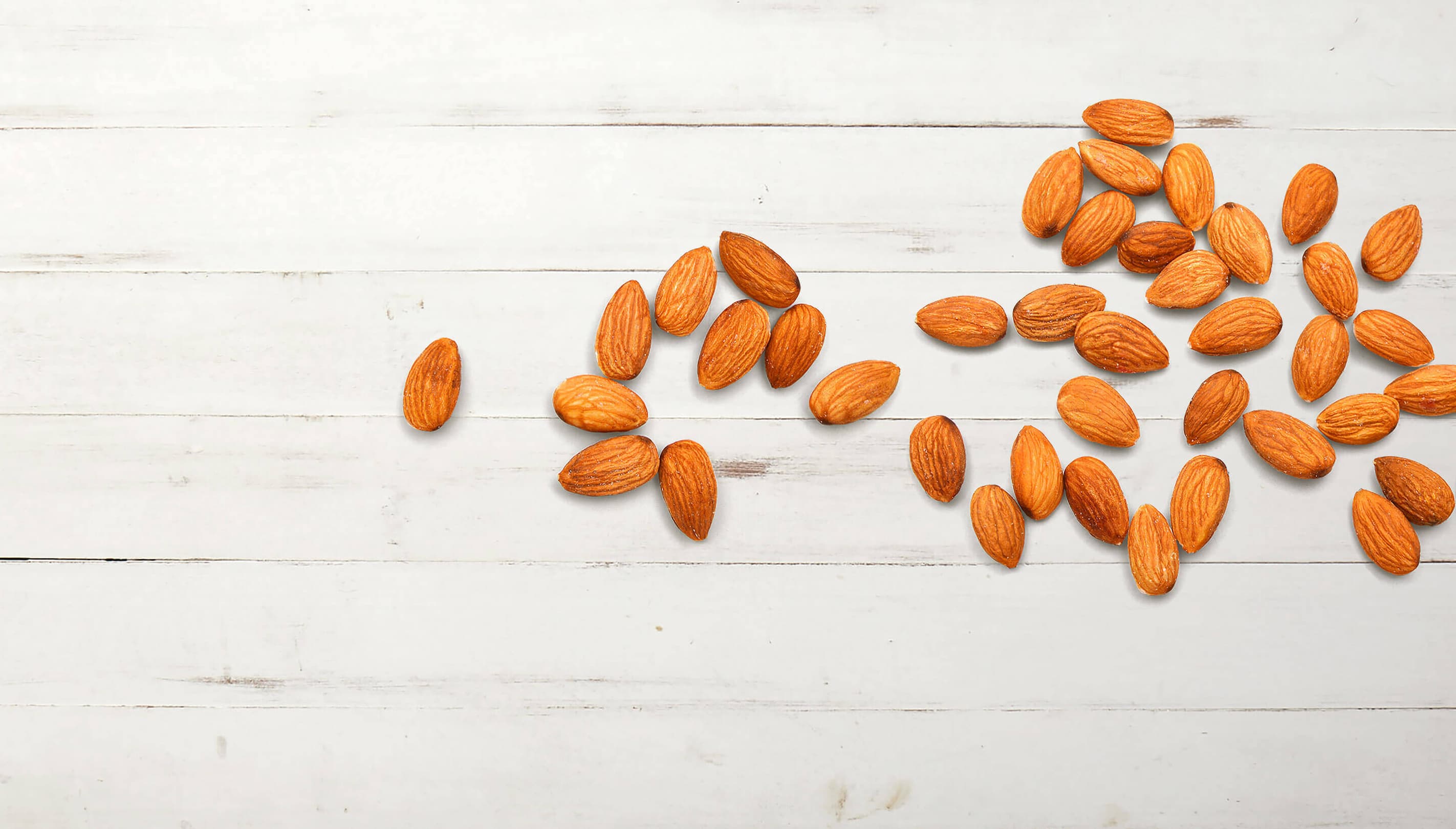 Almonds displayed on a wood background