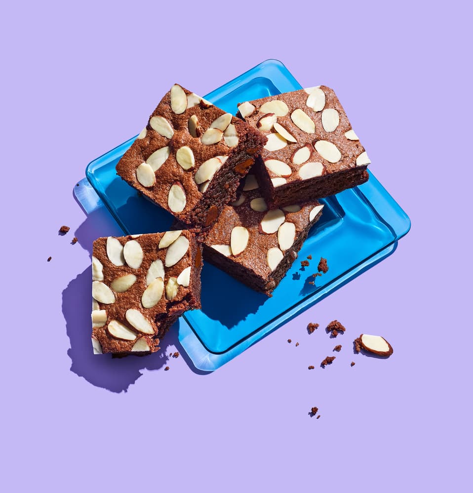 Plate full of gluten-free double chocolate brownies with Blue Diamond Natural Sliced Almonds