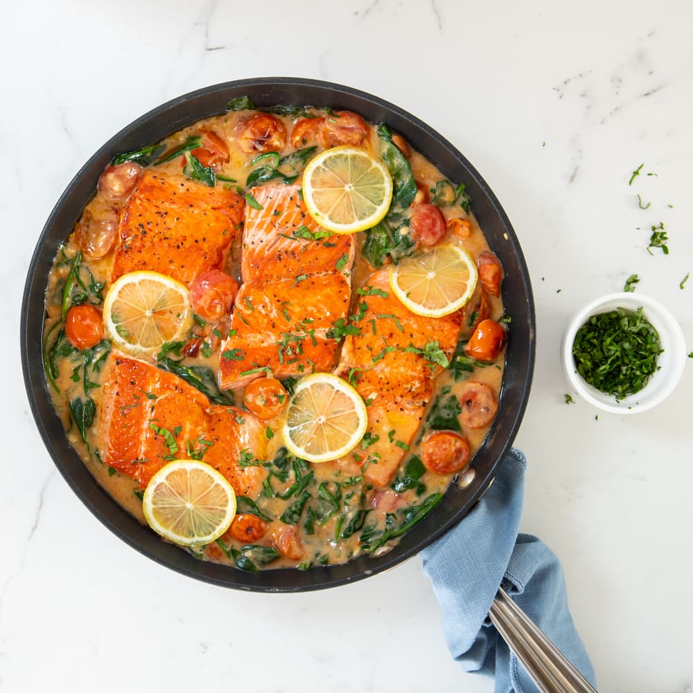 Pan full of creamy tuscan butter salmon fillets