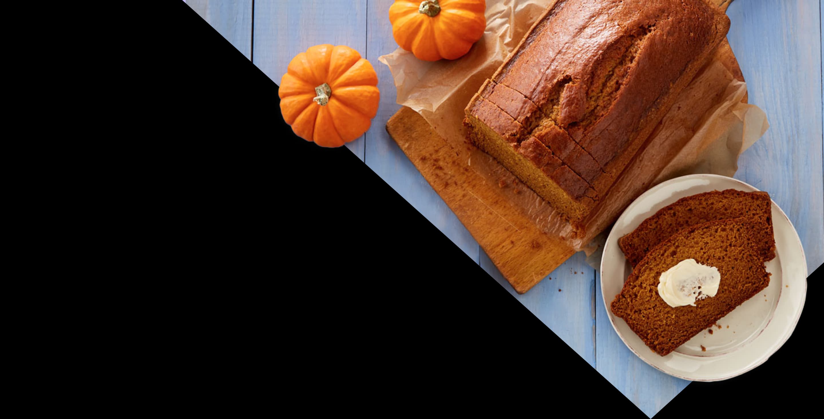 Pumpkin bread with small pumpkins on a blue table