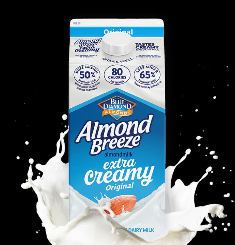 Extra Creamy Original Almondmilk emerging from a splash of milk.