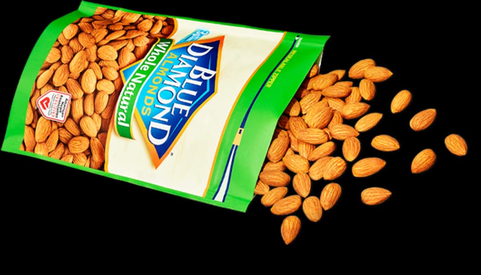 Almonds spilling out of a bag of Whole Natural Blue Diamond Almonds