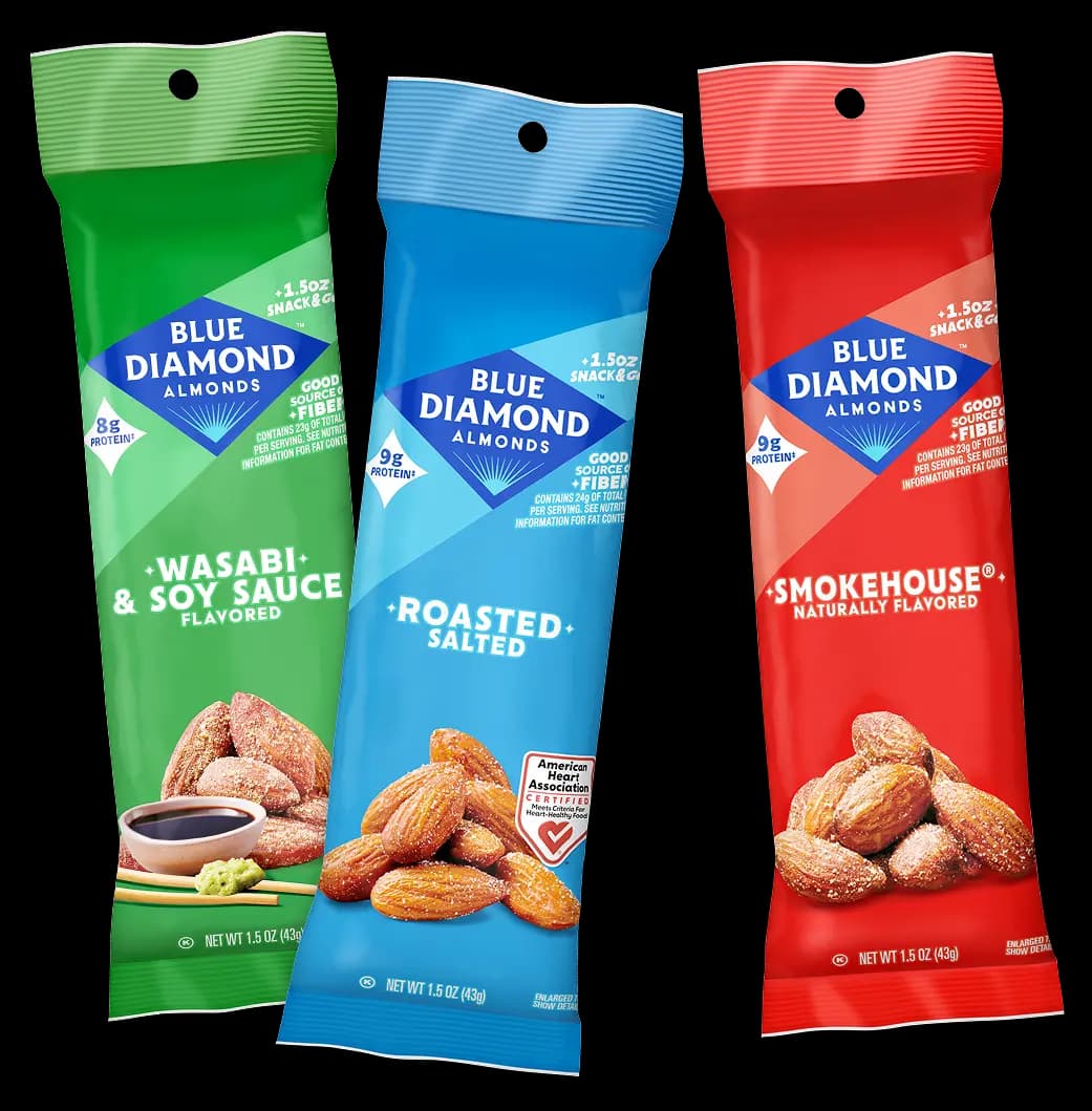 Three Blue Diamond almond snack packs: Wasabi & Soy Sauce, Roasted Salted, and Smokehouse flavors, displayed upright with almonds shown on each package.